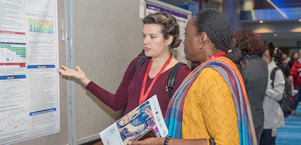 Attendees discussing an abstract poster